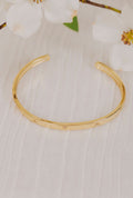 gold cuff bracelet with cubic zirconia triangles