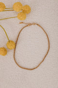 Gold plated stainless steel. Gold mesh chain necklace with a lobster clasp and bead accents.