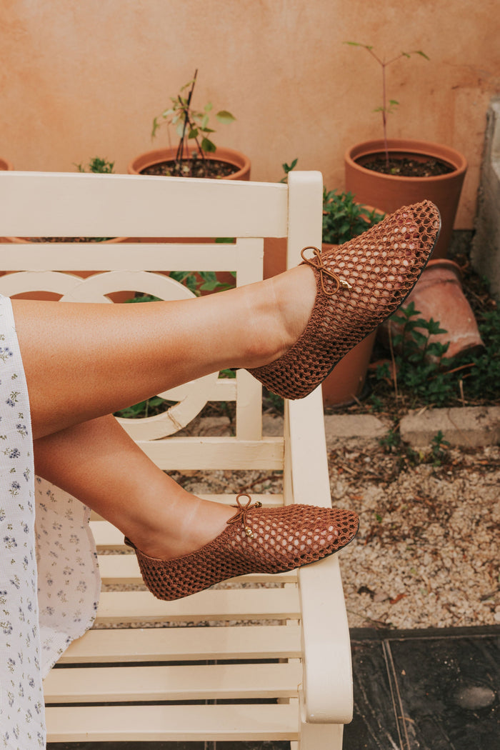 brown woven flats with bow
