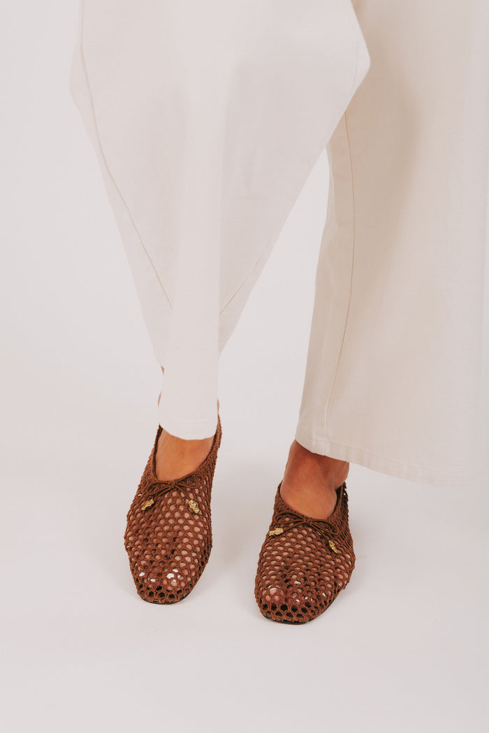 brown woven flats with bow