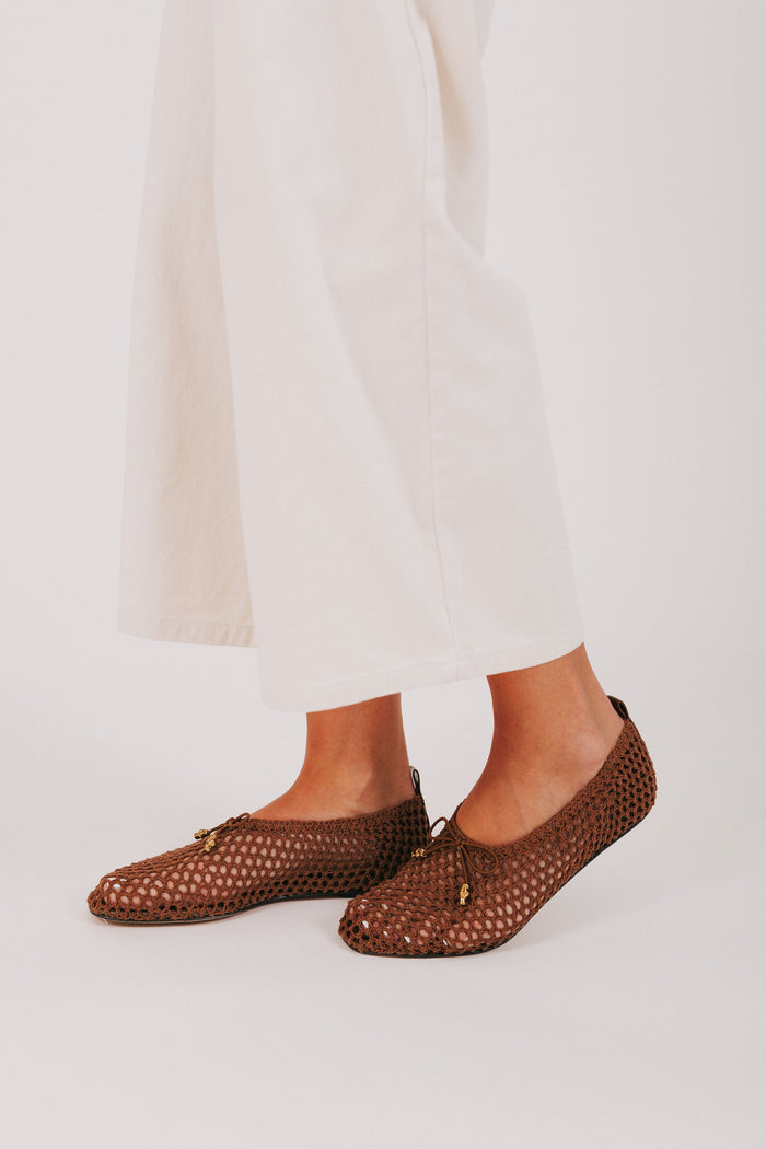 brown woven flats with bow
