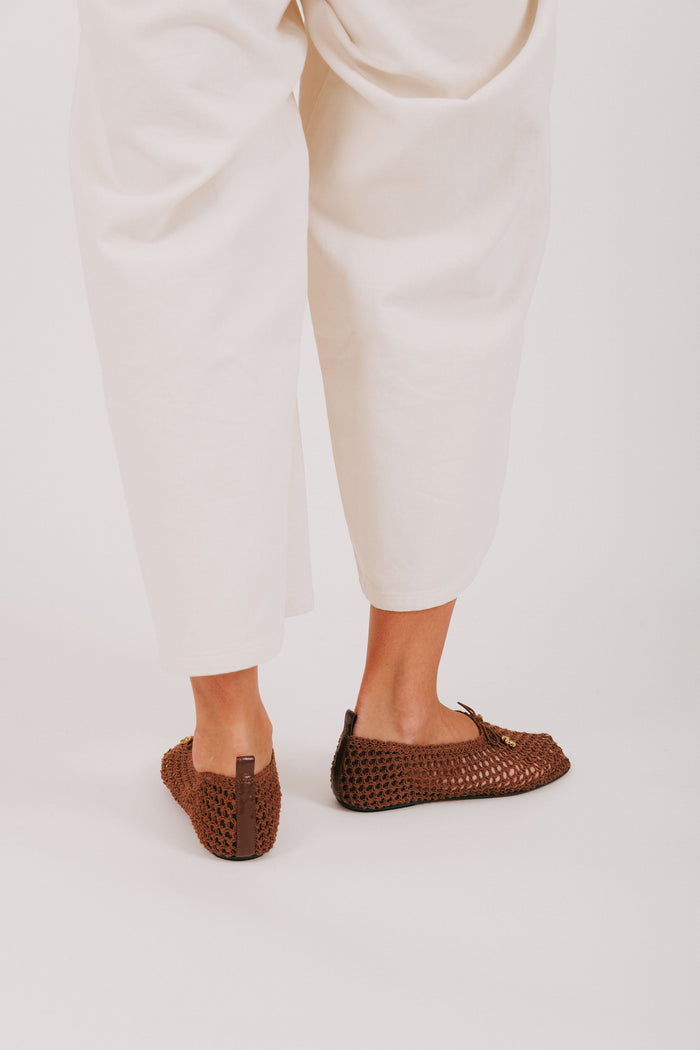 brown woven flats with bow