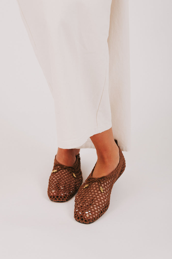 brown woven flats with bow