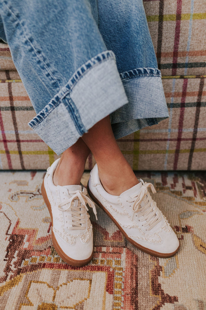 White lace up shoes with brown soles