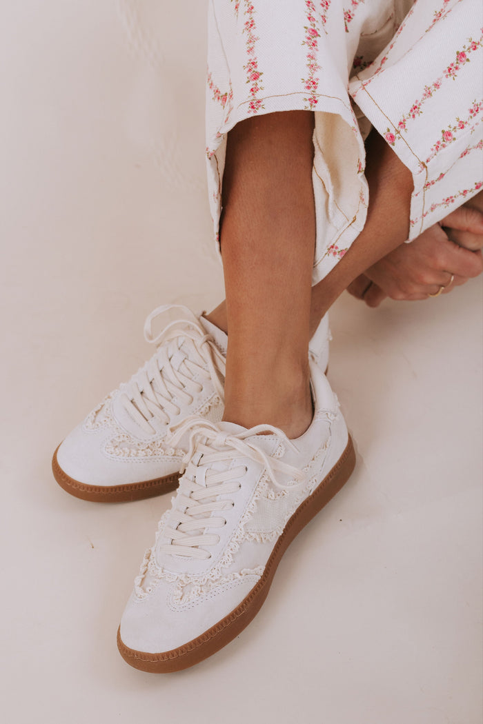 White lace up shoes with brown soles
