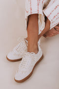White lace up shoes with brown soles