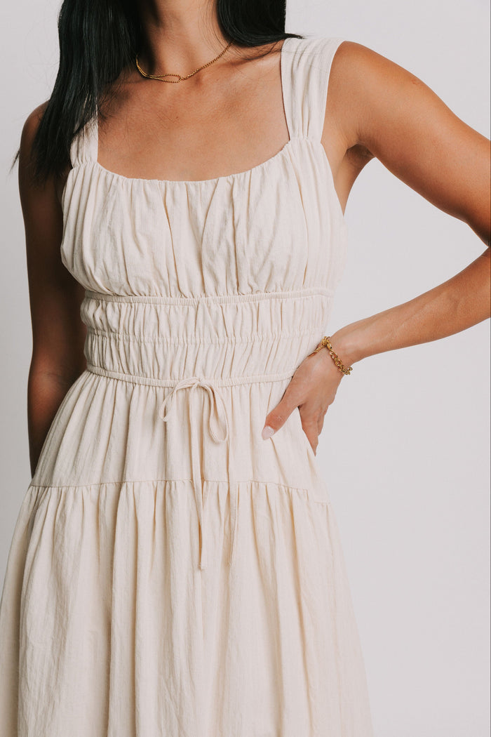 sleeveless cream midi dress with gathered bodice close