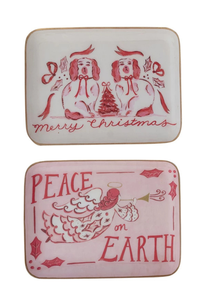 Two Christmas-themed trays with red illustrations and text on an ivory or pink background with gold edge