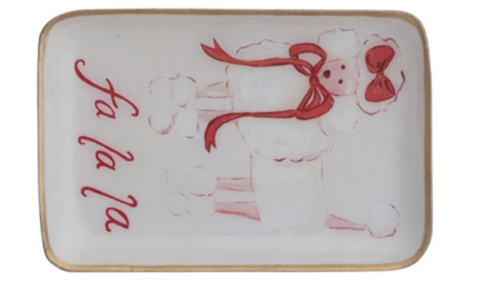 Decorative holiday plate with a poodle with a red ribbon, and 'fa la la' text on a white background with a gold edge.