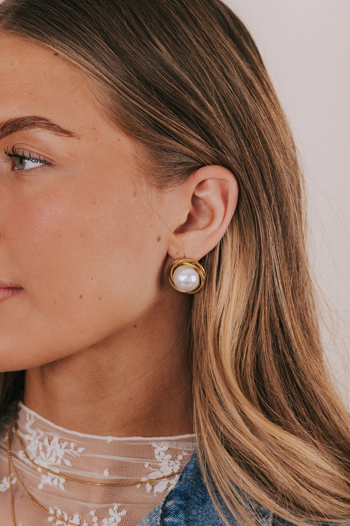 Gold colored layers earrings with large faux pearl center