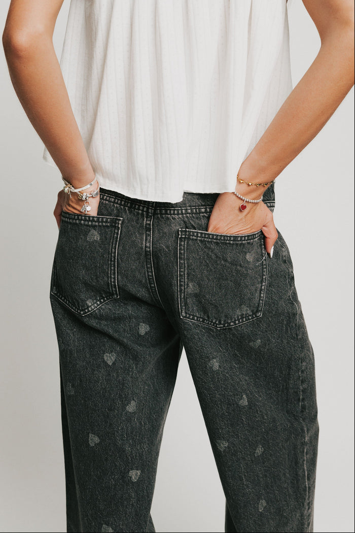 washed black barrel jeans with heart print back pockets
