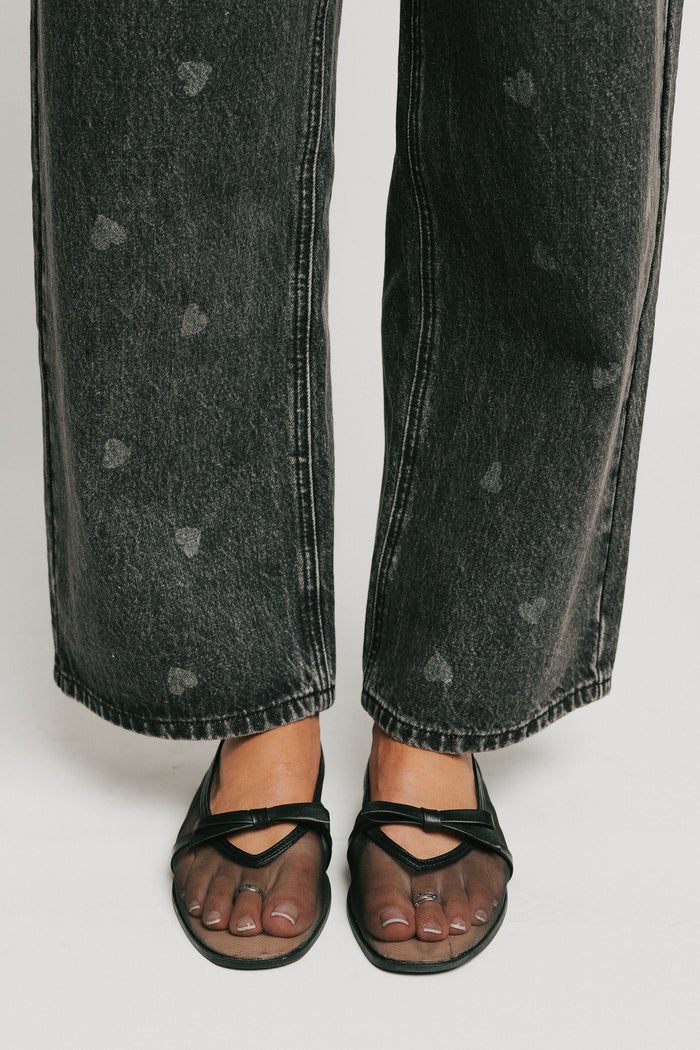 washed black barrel jeans with heart print bottoms