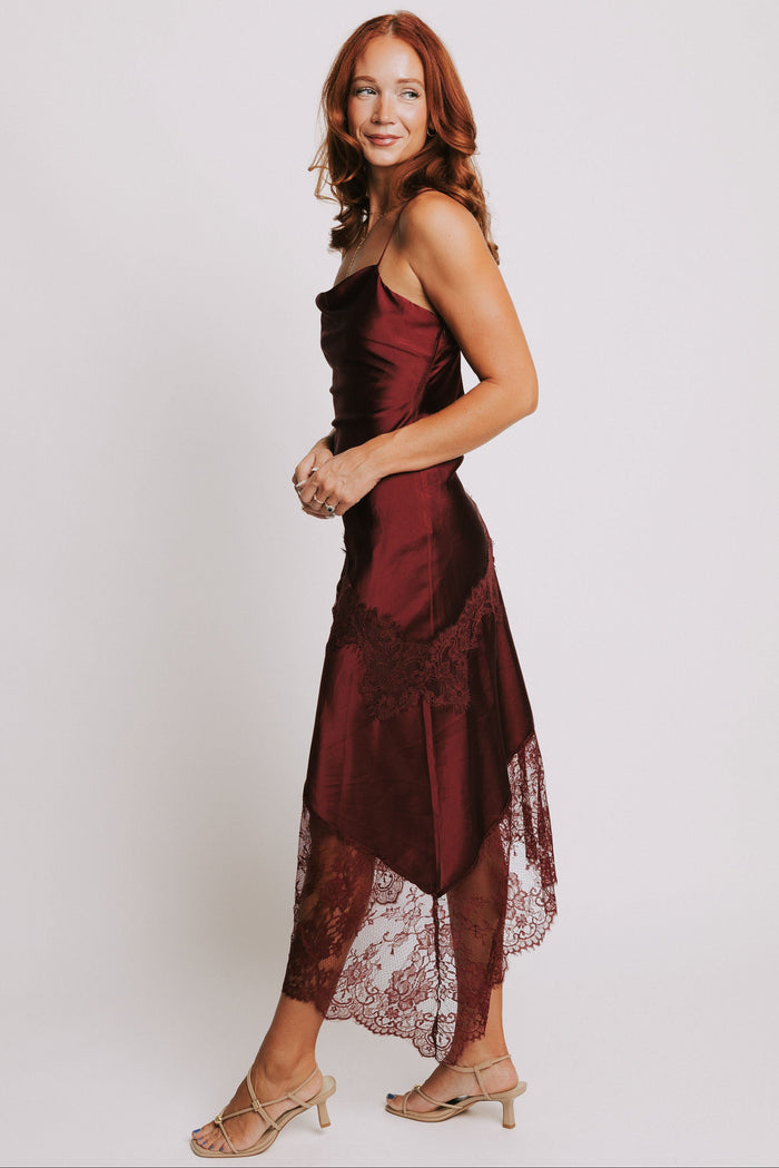 cowl neck dress with lace trimmed asymmetric hemline side