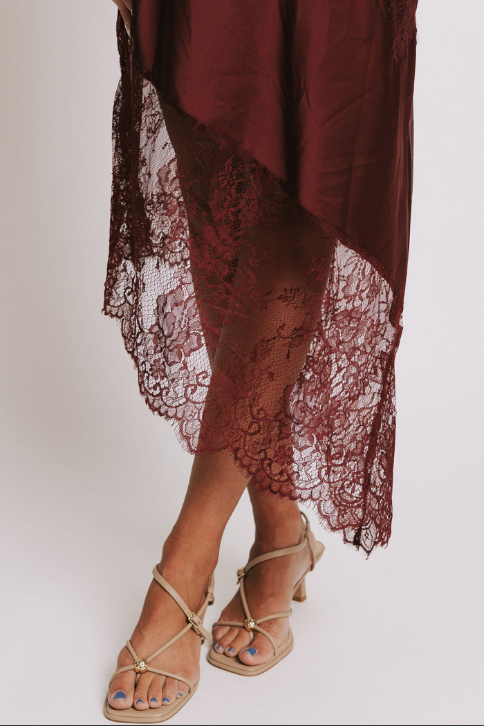 cowl neck dress with lace trimmed asymmetric hemline detail