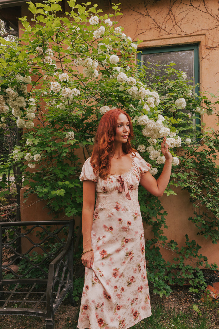 Pink slip dress with lace details, velvet bow, and short puff sleeves