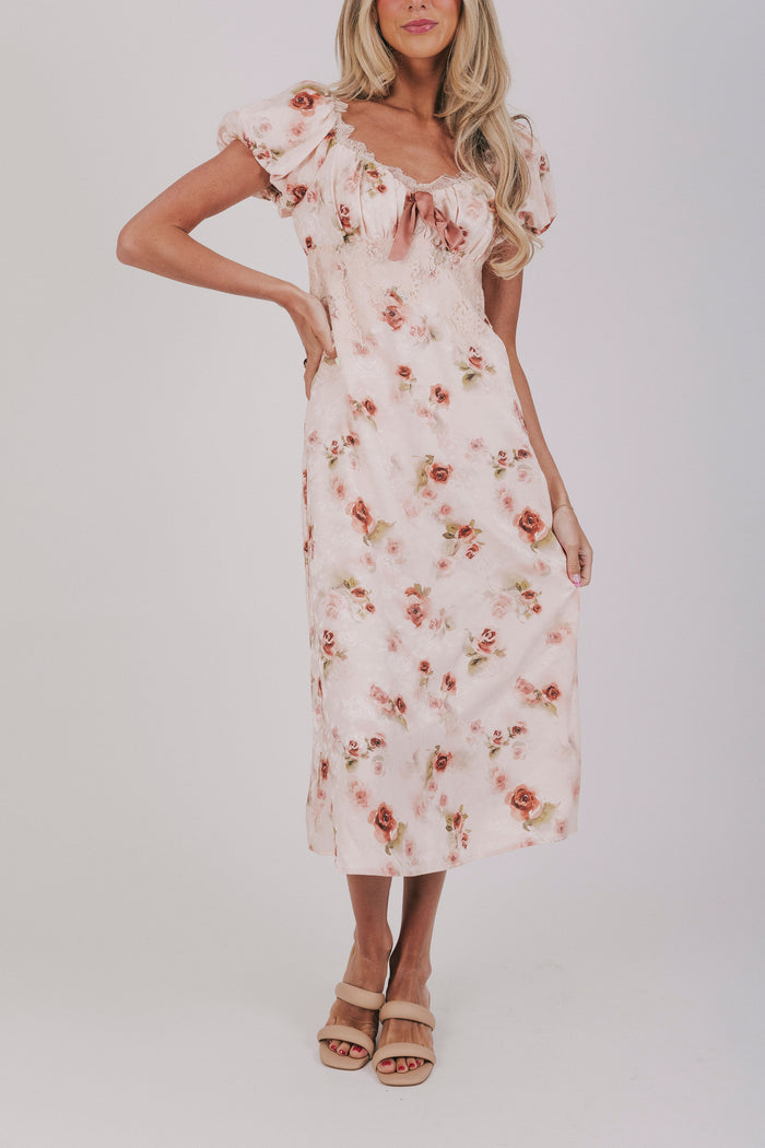 Pink slip dress with lace details, velvet bow, and short puff sleeves