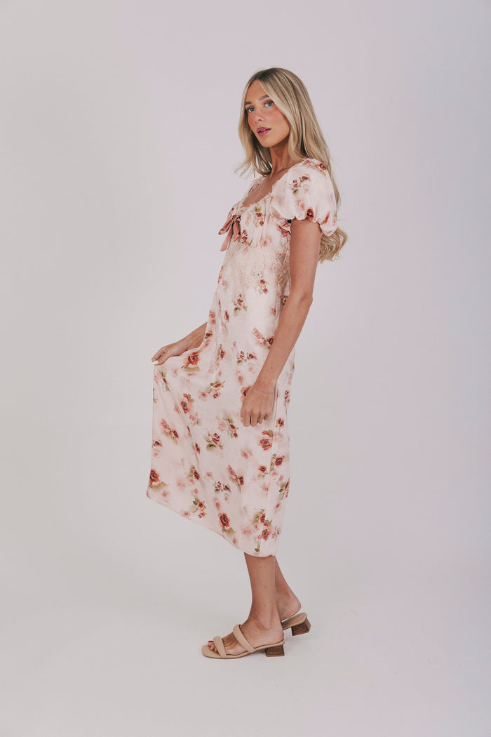 Pink slip dress with lace details, velvet bow, and short puff sleeves