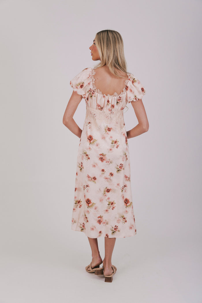 Pink slip dress with lace details, velvet bow, and short puff sleeves