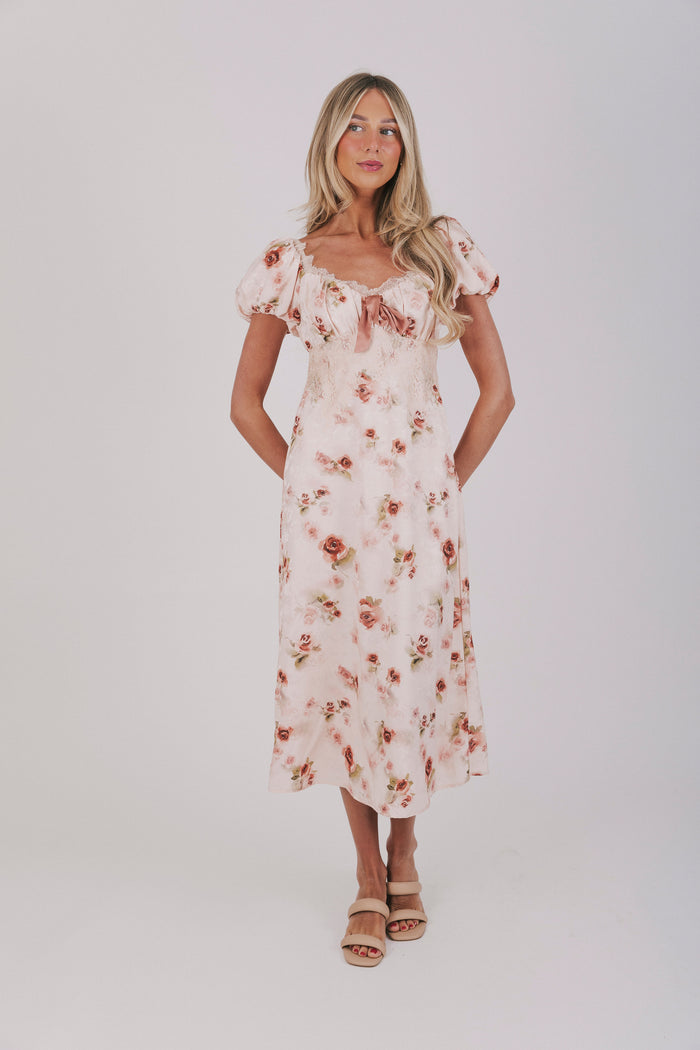 Pink slip dress with lace details, velvet bow, and short puff sleeves