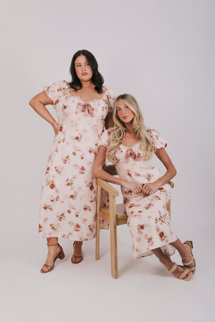 Pink slip dress with lace details, velvet bow, and short puff sleeves