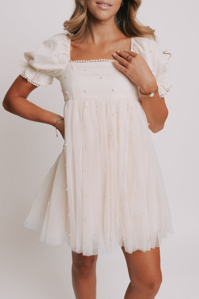 champagne babydoll puff sleeve dress with pearl details close