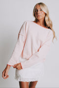light pink sweater with raw seams and rolled edges