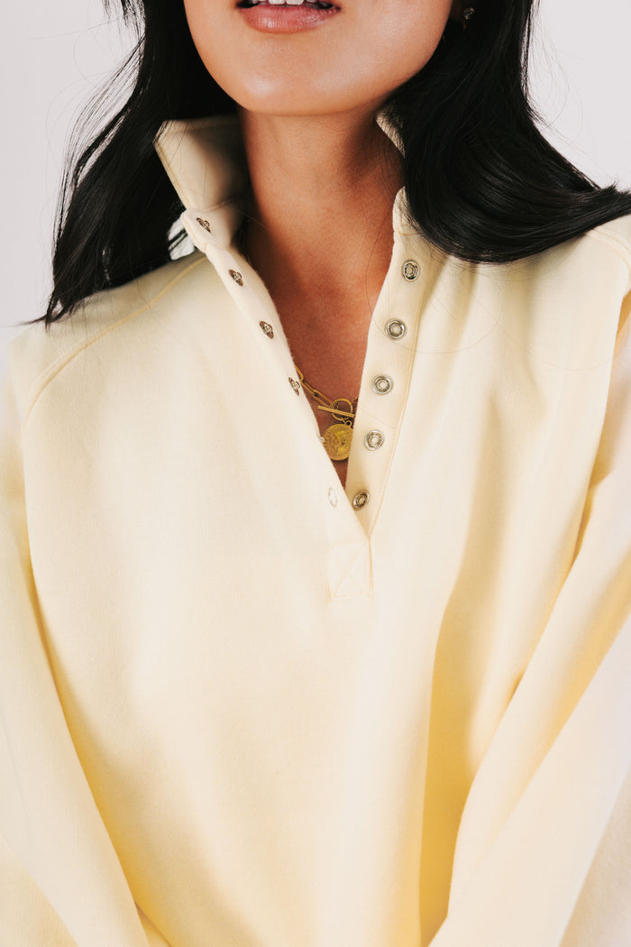 pale yellow partial button down sweatshirt close