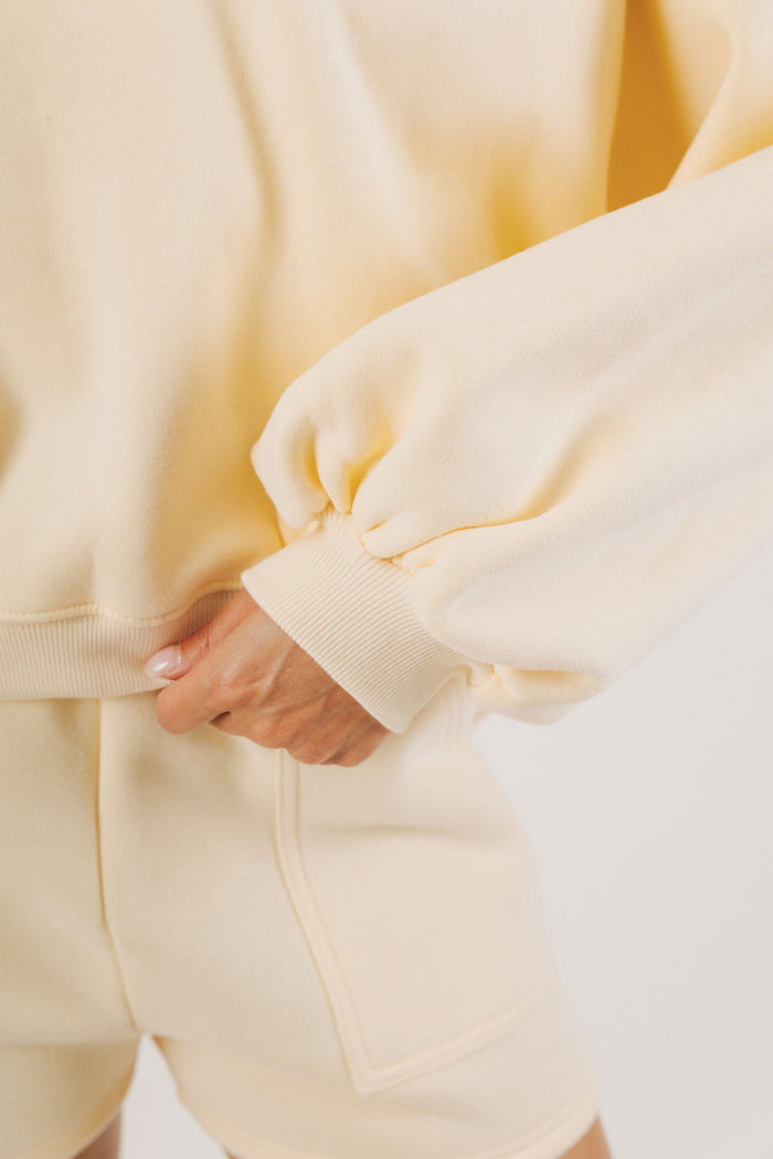 pale yellow partial button down sweatshirt sleeves