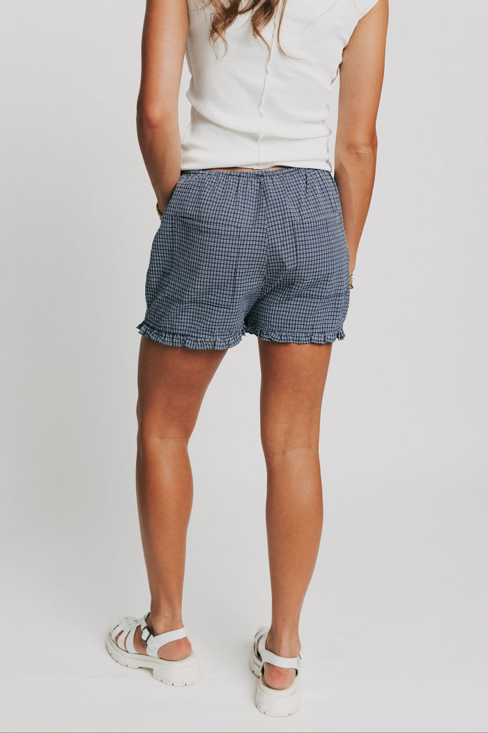 navy gingham shorts with ruffled hem back