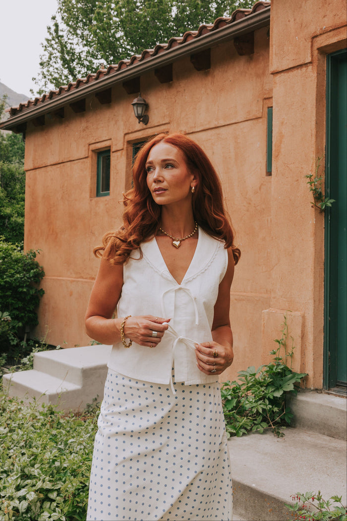 white sleeveless vest with bows front