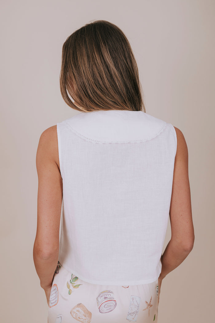 white sleeveless vest with bows back