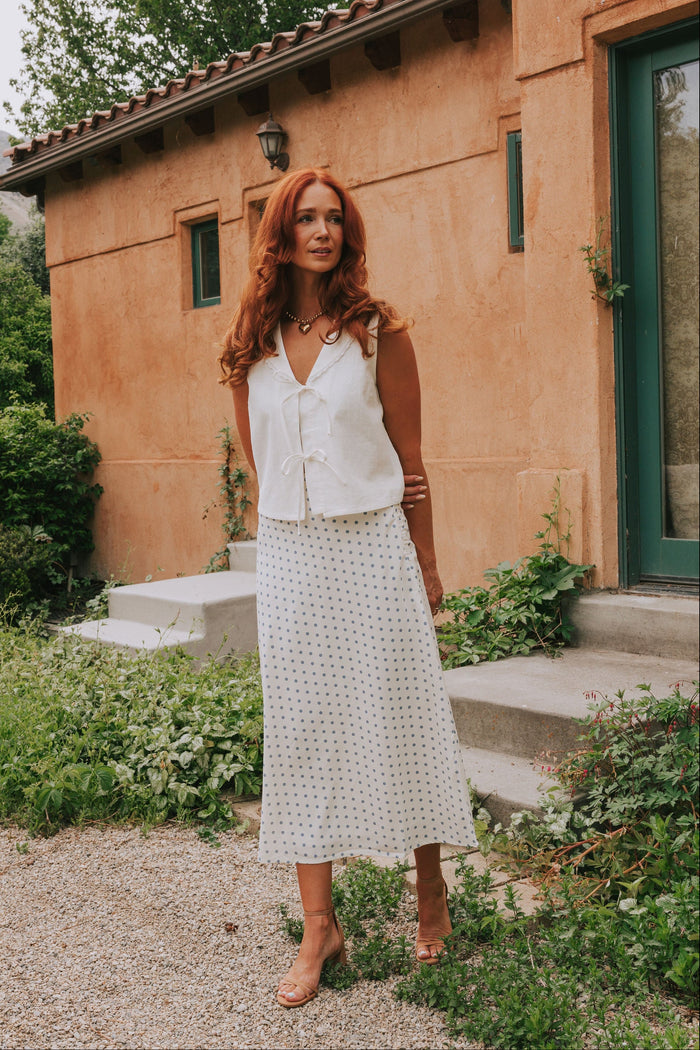 white sleeveless vest with bows front