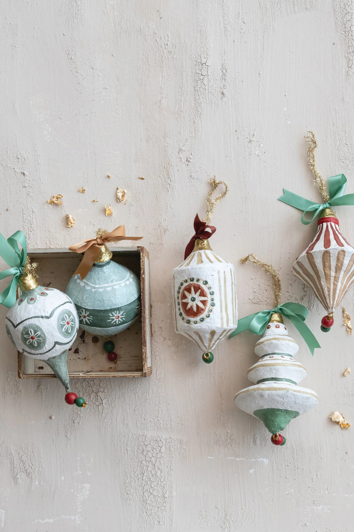 Decorative Christmas ornaments on a textured white surface