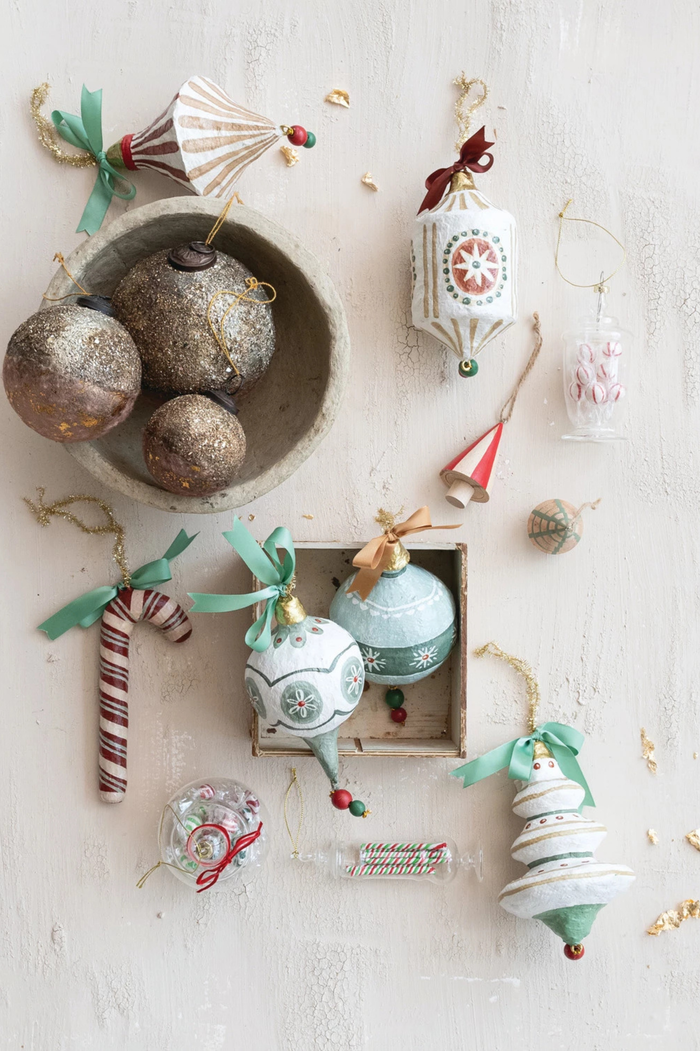 Decorative Christmas ornaments on a light wooden surface