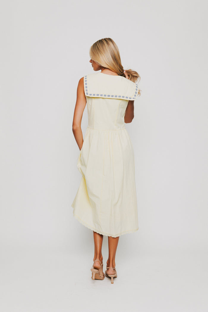 yellow midi dress with pan collar and blue ribbon detail back