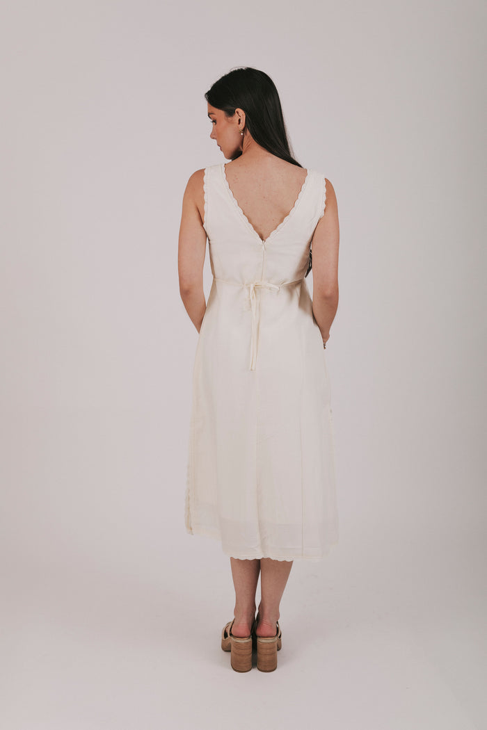 Midi dress that comes in 2 colors, off white and light blue. Sleeveless design with lace trim and side slits.