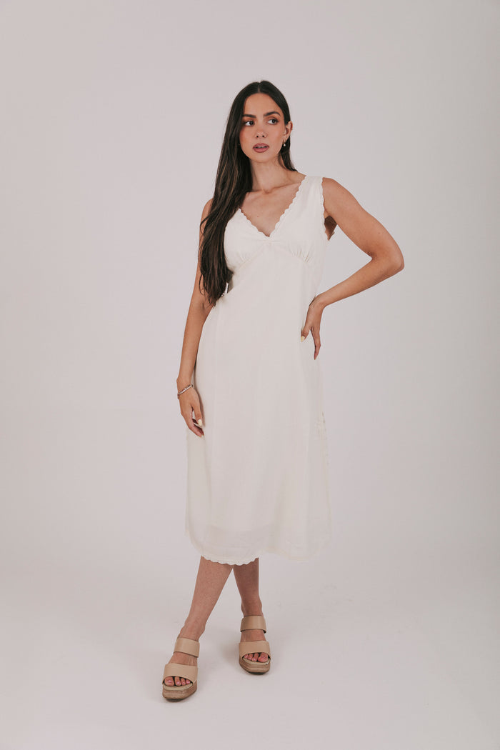 Midi dress that comes in 2 colors, off white and light blue. Sleeveless design with lace trim and side slits.