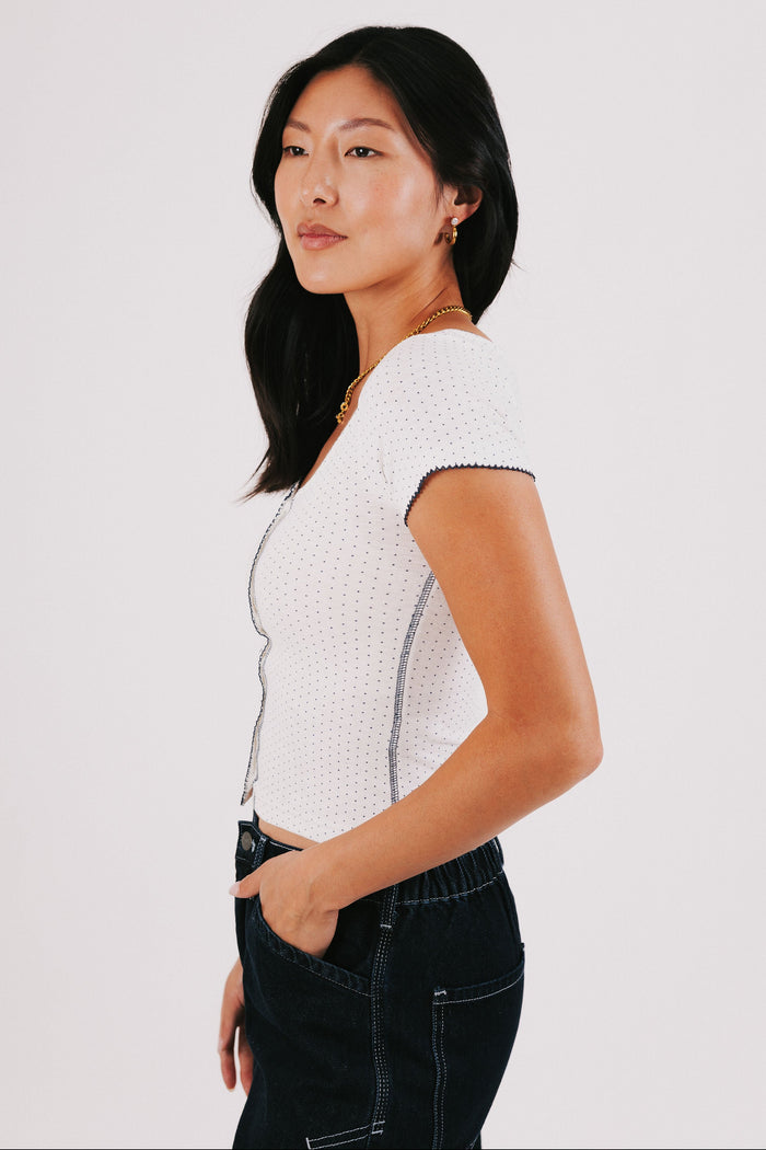 white top with navy polka dots and seams side
