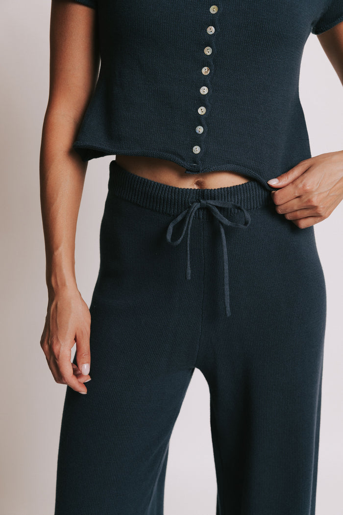 navy wide leg knit pants with rolled edges front