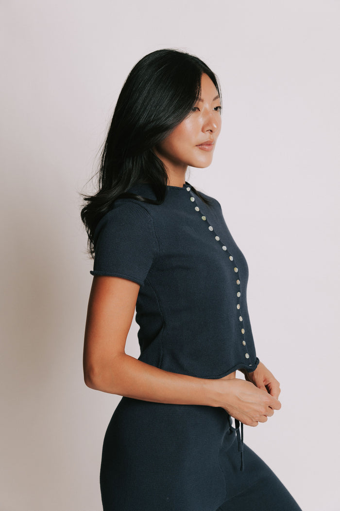 navy short sleeve button down top with rolled edges side
