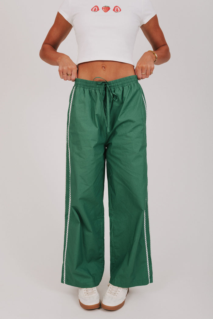 green track pants with lace edges