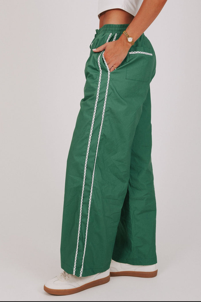 green track pants with lace edges side