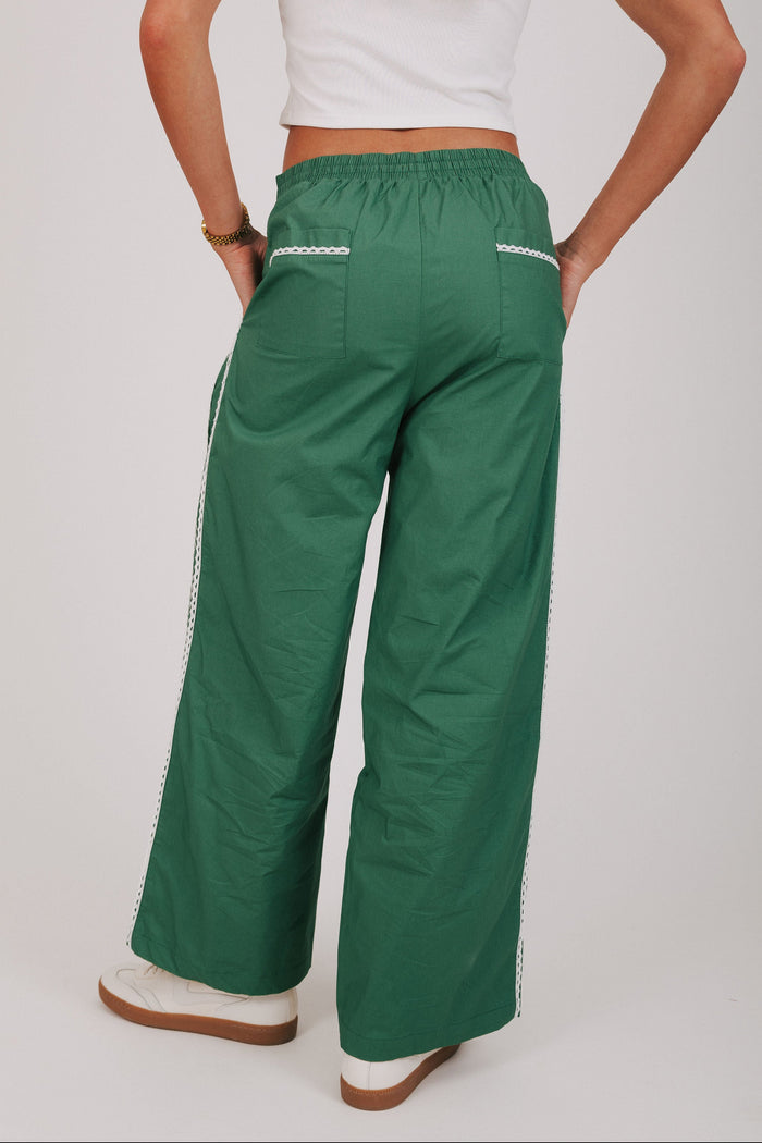 green track pants with lace edges back