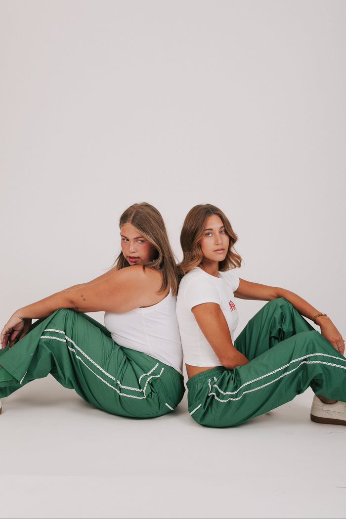 green track pants with lace edges models full look