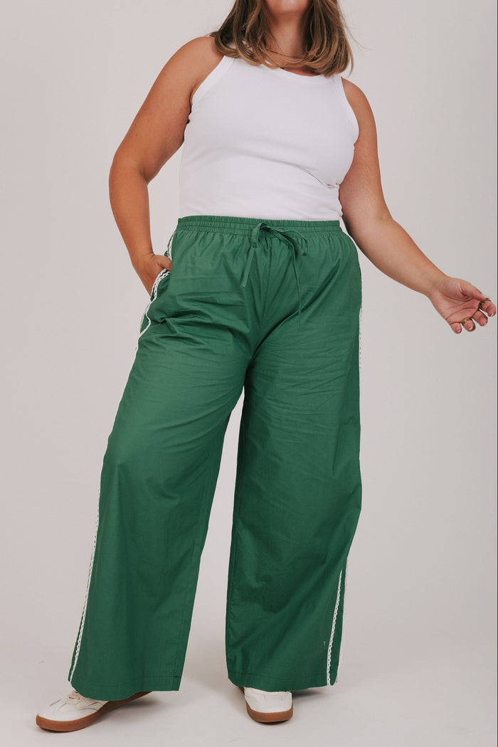 green track pants with lace edges plus