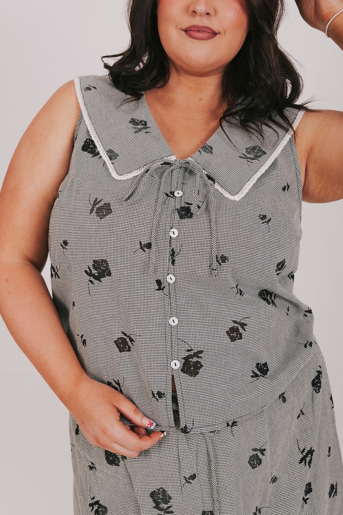 gingham sleeveless top with sheer black flowers and buttons down the front