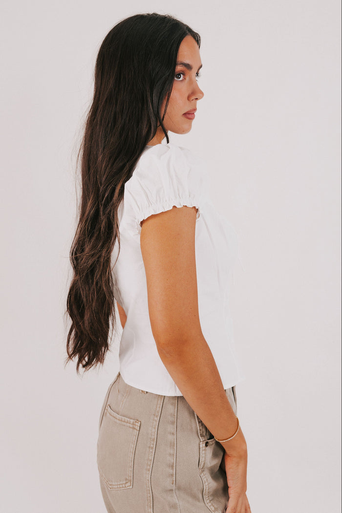white top with puff sleeves and bow keyhole side