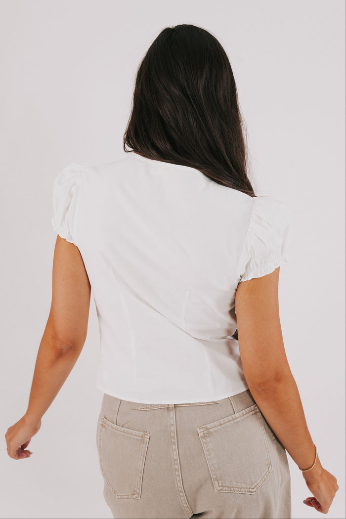 white top with puff sleeves and bow keyhole back