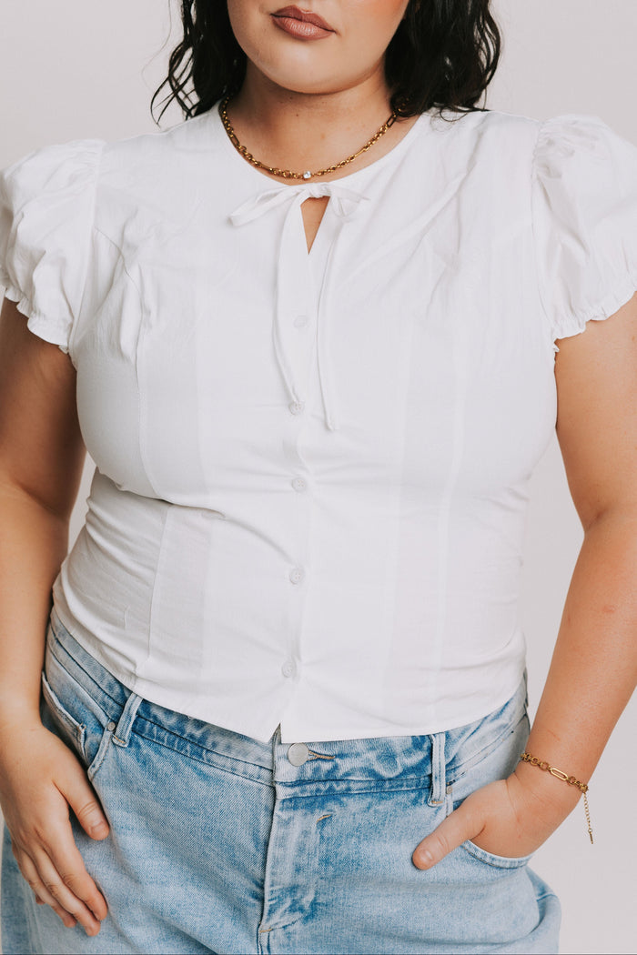 white top with puff sleeves and bow keyhole plus front