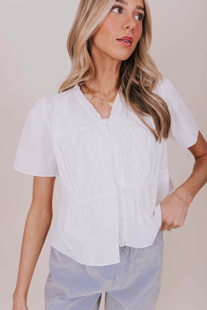 white v neck ruffled tied top detail